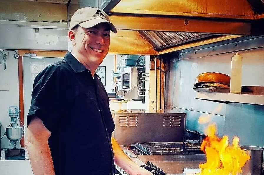 Restaurant kitchen at full service — a visual metaphor for proactive capital planning and reserve fund management